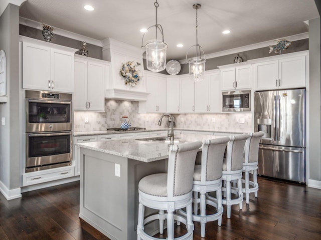 2235 Forestview Ln, Delaware, OH 43015 - kitchen with stainless steel appliances, tasteful backsplash, dark wood-type flooring, a kitchen island with sink, and recessed lighting