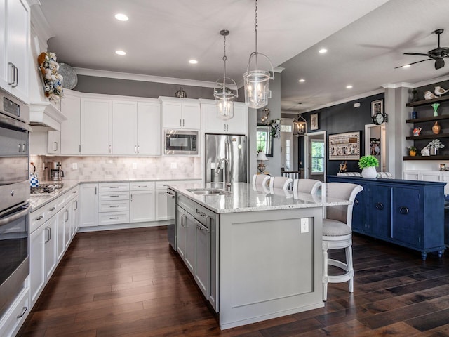 2235 Forestview Ln, Delaware, OH 43015 - kitchen featuring appliances with stainless steel finishes, crown molding, recessed lighting, a kitchen breakfast bar, and backsplash