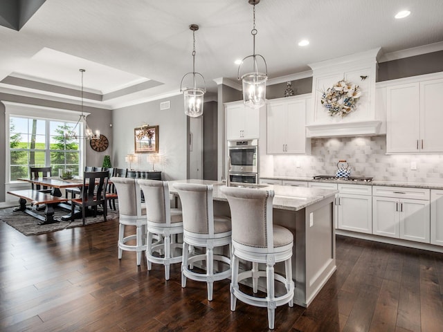 2235 Forestview Ln, Delaware, OH 43015 - kitchen with stainless steel appliances, tasteful backsplash, light stone countertops, recessed lighting, and a kitchen island with sink