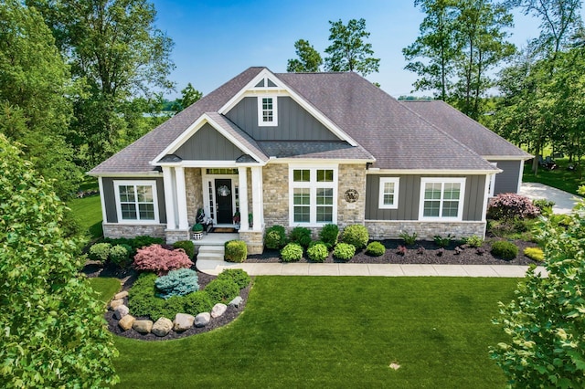 2235 Forestview Ln, Delaware, OH 43015 - craftsman-style house with board and batten siding, stone siding, a front yard, and a shingled roof