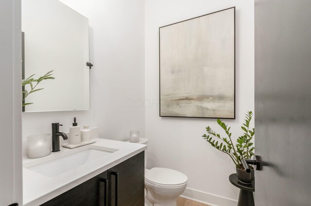 312 Cornelius St, Columbus, OH 43215 - half bath featuring vanity and wood finished floors