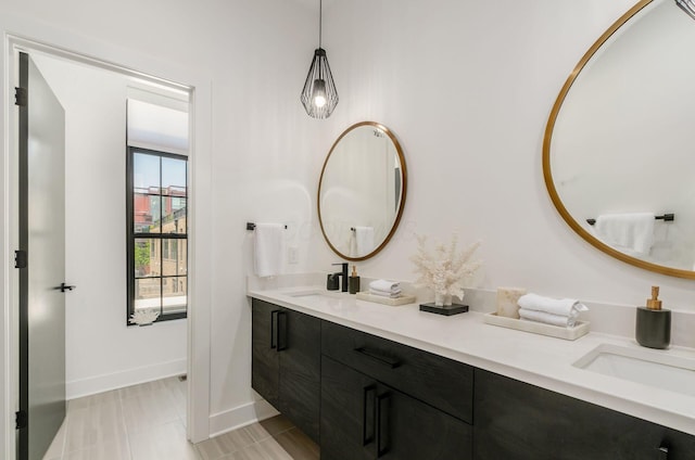 312 Cornelius St, Columbus, OH 43215 - bathroom with double vanity and baseboards