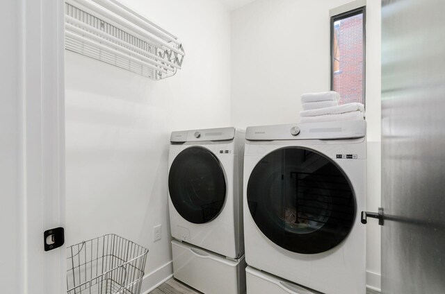 312 Cornelius St, Columbus, OH 43215 - laundry room with washer and clothes dryer and wood finished floors
