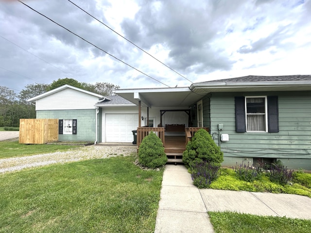 3049 Palace Heights Ln NW, Malta, OH 43758 - view of front of house featuring an attached garage, driveway, roof with shingles, and a wooden deck