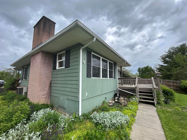 3049 Palace Heights Ln NW, Malta, OH 43758 - view of home's exterior with a wooden deck, a chimney, crawl space, and central AC unit