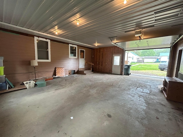3049 Palace Heights Ln NW, Malta, OH 43758 - garage featuring a garage door opener and wooden walls