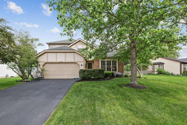 388 Slate Run Dr, Powell, OH 43065 - view of front of property featuring an attached garage, asphalt driveway, stucco siding, and a front lawn