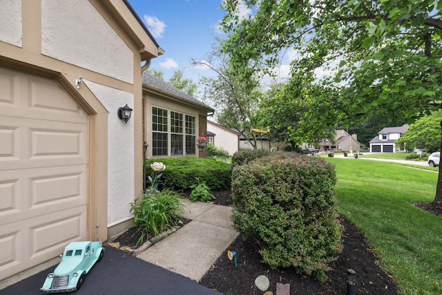 388 Slate Run Dr, Powell, OH 43065 - property entrance featuring a lawn, stucco siding, and a garage