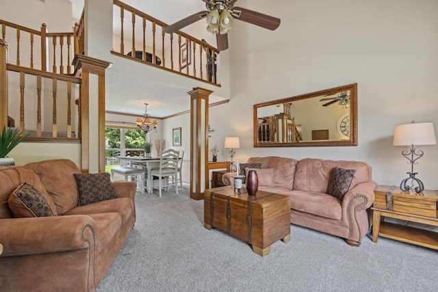 388 Slate Run Dr, Powell, OH 43065 - living area with a ceiling fan, carpet, a chandelier, ornamental molding, and a high ceiling