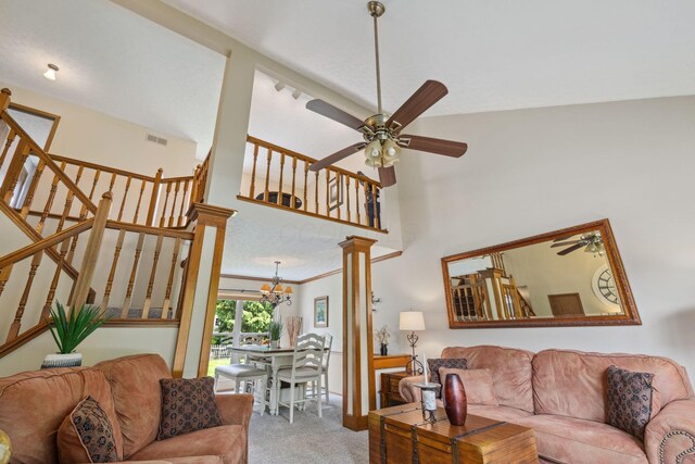 388 Slate Run Dr, Powell, OH 43065 - living area with a ceiling fan, light colored carpet, stairway, a chandelier, and a high ceiling