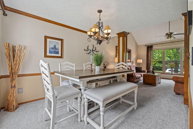388 Slate Run Dr, Powell, OH 43065 - dining room featuring light colored carpet, ceiling fan, a chandelier, baseboards, and lofted ceiling