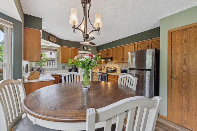 388 Slate Run Dr, Powell, OH 43065 - dining room with a chandelier, wood finished floors, and a textured ceiling