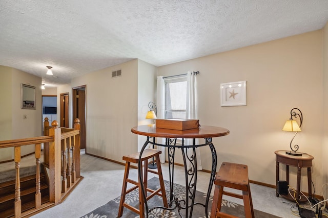 388 Slate Run Dr, Powell, OH 43065 - carpeted dining space with a textured ceiling and baseboards