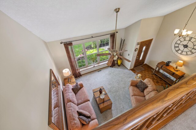 388 Slate Run Dr, Powell, OH 43065 - carpeted living room with vaulted ceiling, a chandelier, and baseboards