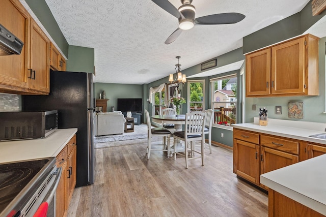 388 Slate Run Dr, Powell, OH 43065 - kitchen featuring stainless steel microwave, a textured ceiling, ceiling fan, light wood-type flooring, and light countertops