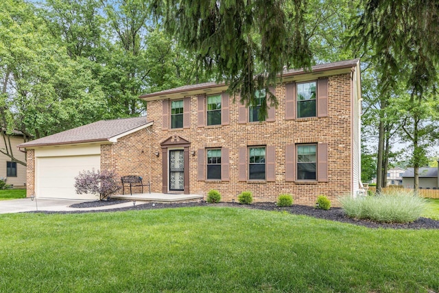 544 Waring Way, Columbus, OH 43213 - view of front of property with driveway, brick siding, a garage, and a front yard