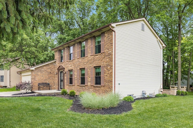 544 Waring Way, Columbus, OH 43213 - view of front of home with a front lawn, a garage, and brick siding