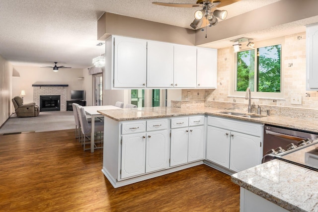 544 Waring Way, Columbus, OH 43213 - kitchen with ceiling fan, a sink, dark wood finished floors, a fireplace, and a textured ceiling