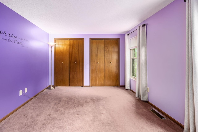 544 Waring Way, Columbus, OH 43213 - unfurnished bedroom featuring multiple closets and carpet flooring