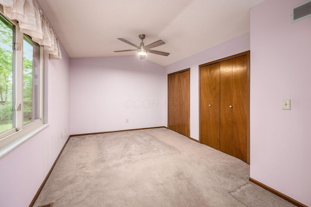 544 Waring Way, Columbus, OH 43213 - unfurnished bedroom with multiple closets, multiple windows, carpet flooring, and vaulted ceiling
