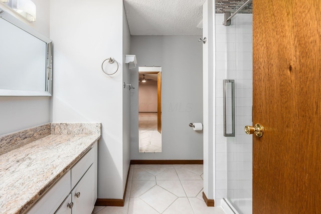 544 Waring Way, Columbus, OH 43213 - full bath featuring a textured ceiling, a shower stall, vanity, baseboards, and tile patterned floors
