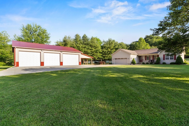 3040 Seney Rd Unit 912, Chillicothe, OH 45601 - view of front of house with driveway, a front lawn, metal roof, and a detached garage