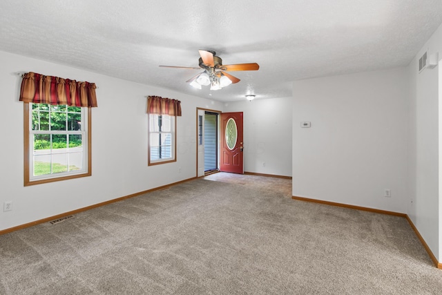3040 Seney Rd Unit 912, Chillicothe, OH 45601 - carpeted empty room featuring plenty of natural light, baseboards, a ceiling fan, and a textured ceiling
