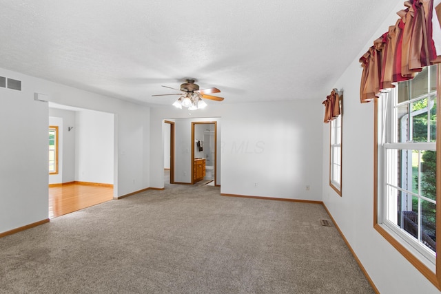 3040 Seney Rd Unit 912, Chillicothe, OH 45601 - empty room featuring light colored carpet, ceiling fan, baseboards, and a textured ceiling