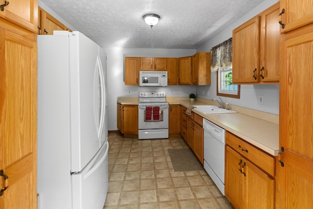 3040 Seney Rd Unit 912, Chillicothe, OH 45601 - kitchen with white appliances, a sink, light countertops, a textured ceiling, and brown cabinetry