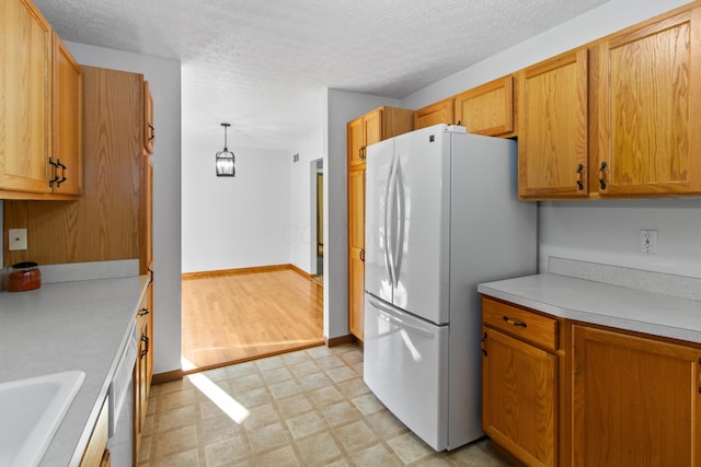 3040 Seney Rd Unit 912, Chillicothe, OH 45601 - kitchen with freestanding refrigerator, light flooring, light countertops, a textured ceiling, and a sink