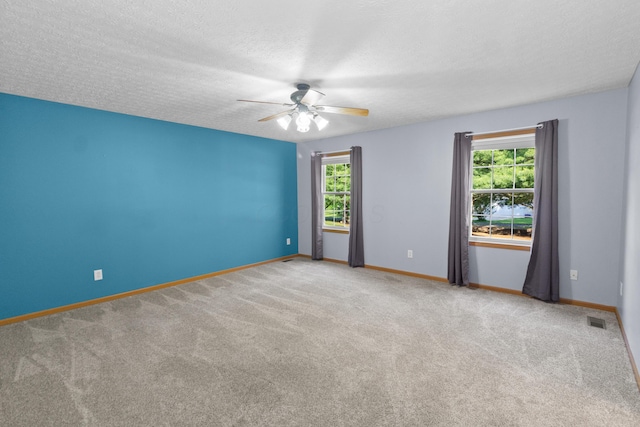 3040 Seney Rd Unit 912, Chillicothe, OH 45601 - spare room featuring healthy amount of natural light, ceiling fan, carpet floors, baseboards, and a textured ceiling