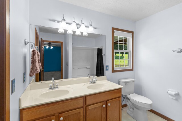3040 Seney Rd Unit 912, Chillicothe, OH 45601 - bathroom with double vanity, toilet, a shower with curtain, baseboards, and a textured ceiling