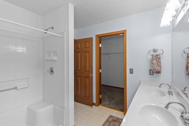 3040 Seney Rd Unit 912, Chillicothe, OH 45601 - bathroom with a shower, double vanity, a spacious closet, and a textured ceiling