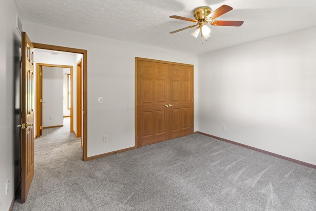 3040 Seney Rd Unit 912, Chillicothe, OH 45601 - unfurnished bedroom with carpet floors, baseboards, a closet, a textured ceiling, and a ceiling fan