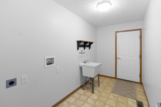 3040 Seney Rd Unit 912, Chillicothe, OH 45601 - washroom with electric dryer hookup, light floors, hookup for a washing machine, a textured ceiling, and baseboards