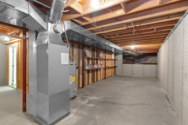 3040 Seney Rd Unit 912, Chillicothe, OH 45601 - unfinished basement with brick wall, electric water heater, and heating unit