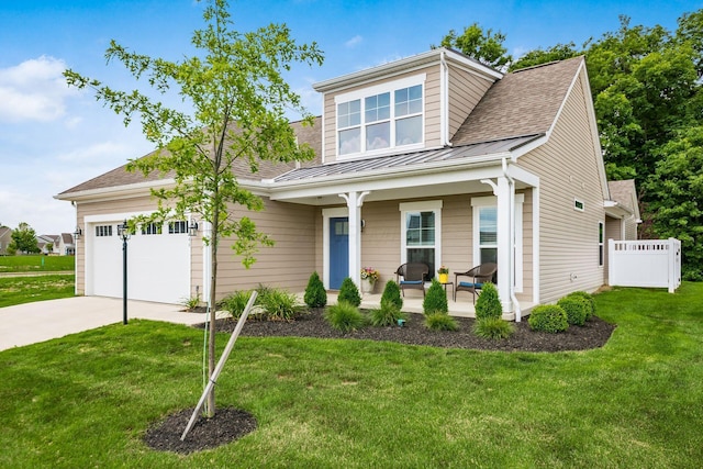 3446 Joberry Loop, Grove City, OH 43123 - view of front of home with covered porch, a standing seam roof, metal roof, driveway, and a garage