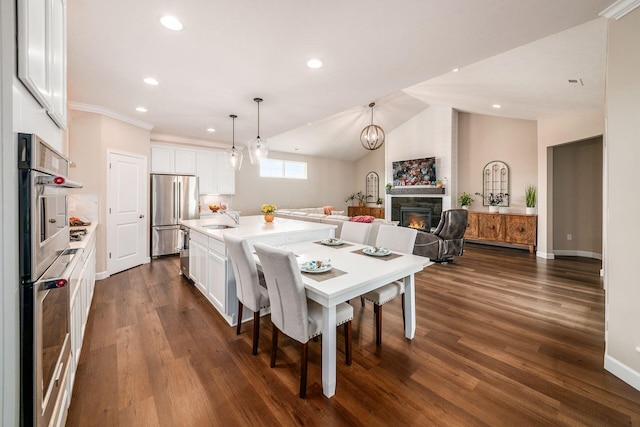 3446 Joberry Loop, Grove City, OH 43123 - dining area featuring a glass covered fireplace, dark wood-style floors, recessed lighting, baseboards, and vaulted ceiling