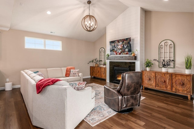 3446 Joberry Loop, Grove City, OH 43123 - living room featuring a chandelier, vaulted ceiling, a glass covered fireplace, dark wood-style flooring, and baseboards