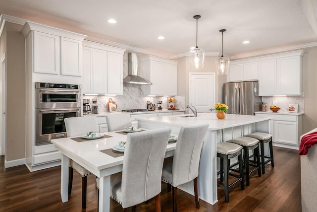 3446 Joberry Loop, Grove City, OH 43123 - kitchen featuring appliances with stainless steel finishes, wall chimney exhaust hood, a sink, an island with sink, and tasteful backsplash