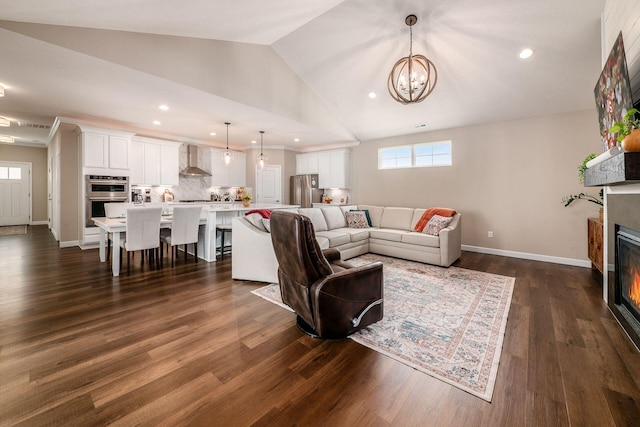 3446 Joberry Loop, Grove City, OH 43123 - living room featuring a glass covered fireplace, a chandelier, vaulted ceiling, recessed lighting, and dark wood finished floors