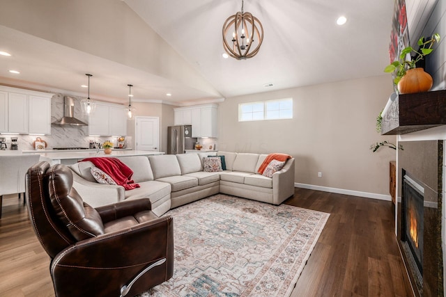 3446 Joberry Loop, Grove City, OH 43123 - living area featuring a glass covered fireplace, a chandelier, vaulted ceiling, baseboards, and dark wood finished floors