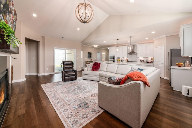 3446 Joberry Loop, Grove City, OH 43123 - living room featuring a lit fireplace, recessed lighting, a chandelier, dark wood-type flooring, and high vaulted ceiling