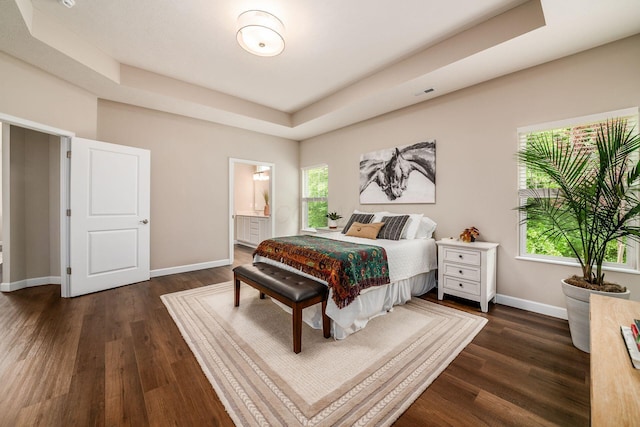 3446 Joberry Loop, Grove City, OH 43123 - bedroom featuring a tray ceiling, dark wood-style floors, baseboards, and ensuite bath