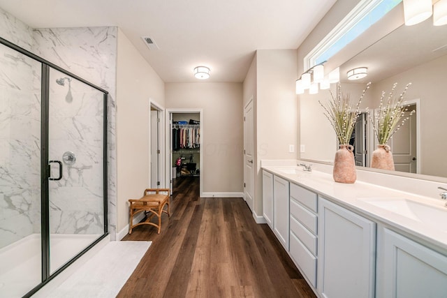 3446 Joberry Loop, Grove City, OH 43123 - full bath featuring wood finished floors, double vanity, a marble finish shower, a spacious closet, and baseboards
