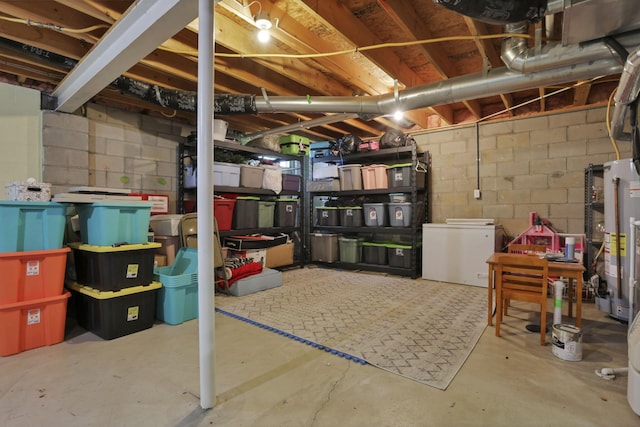 982 Margate Cir, London, OH 43140 - unfinished basement featuring refrigerator, concrete block wall, and water heater