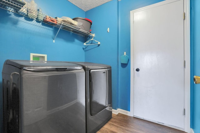 982 Margate Cir, London, OH 43140 - laundry room featuring wood finished floors, washer and clothes dryer, and baseboards