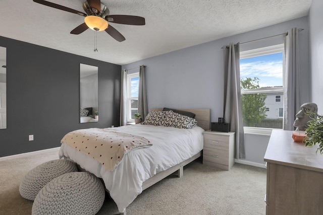 982 Margate Cir, London, OH 43140 - bedroom with light carpet, baseboards, ceiling fan, and a textured ceiling