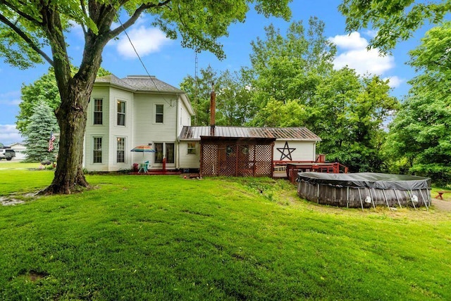 841 Township Highway 52, Nevada, OH 44849 - back of property with a covered pool, a lawn, and a wooden deck