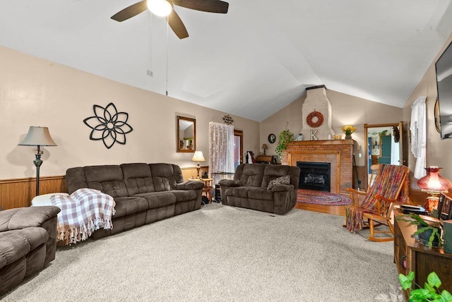 841 Township Highway 52, Nevada, OH 44849 - carpeted living area with lofted ceiling, a ceiling fan, a brick fireplace, and a wainscoted wall